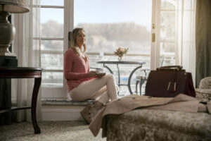 tbh-hotel-luxury-twin-mountain-facing-room-model-drinking-tea-table-mountain-in-background-tmn